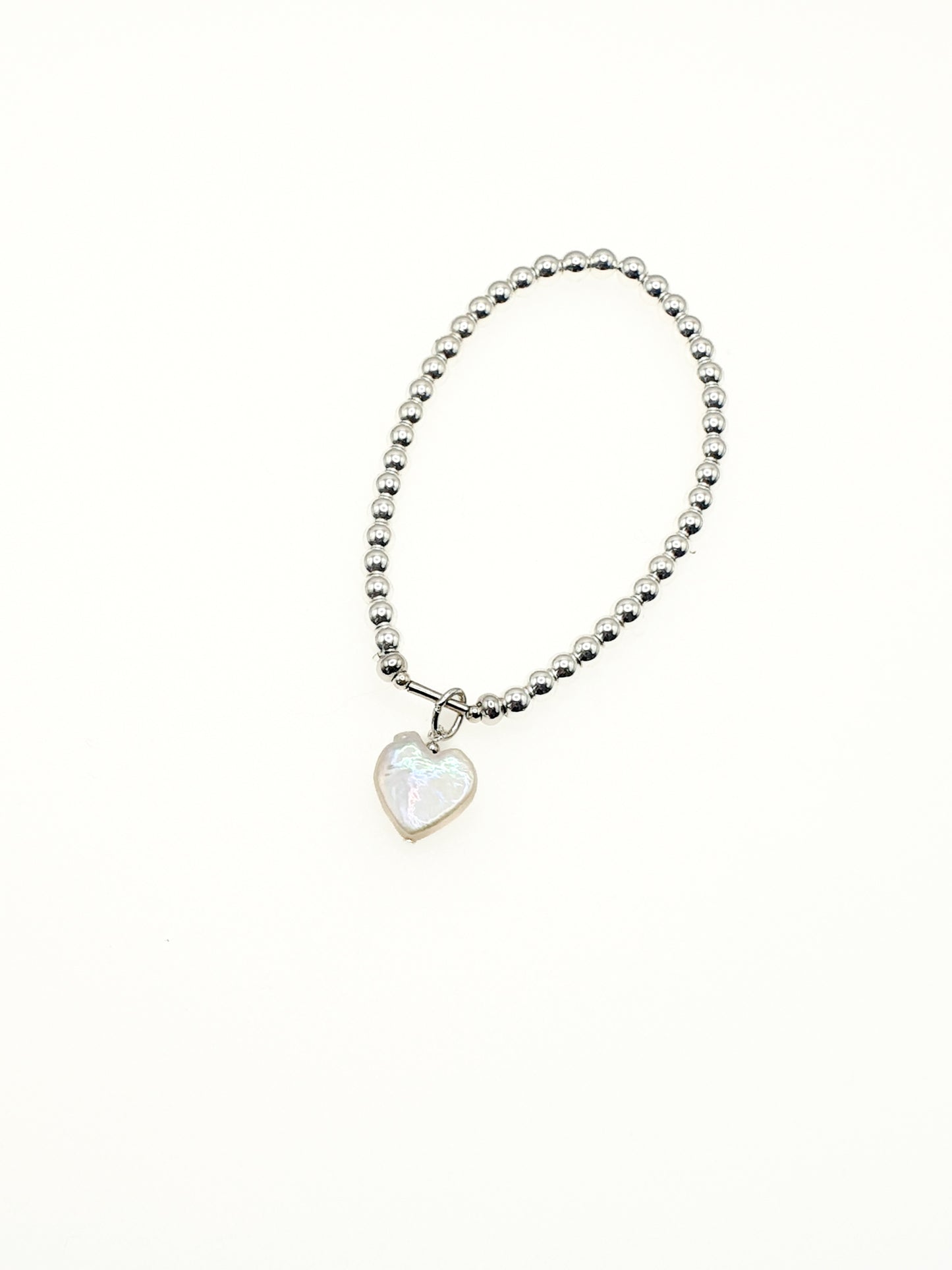 Freshwater pearl heart charm on silver plated hematine