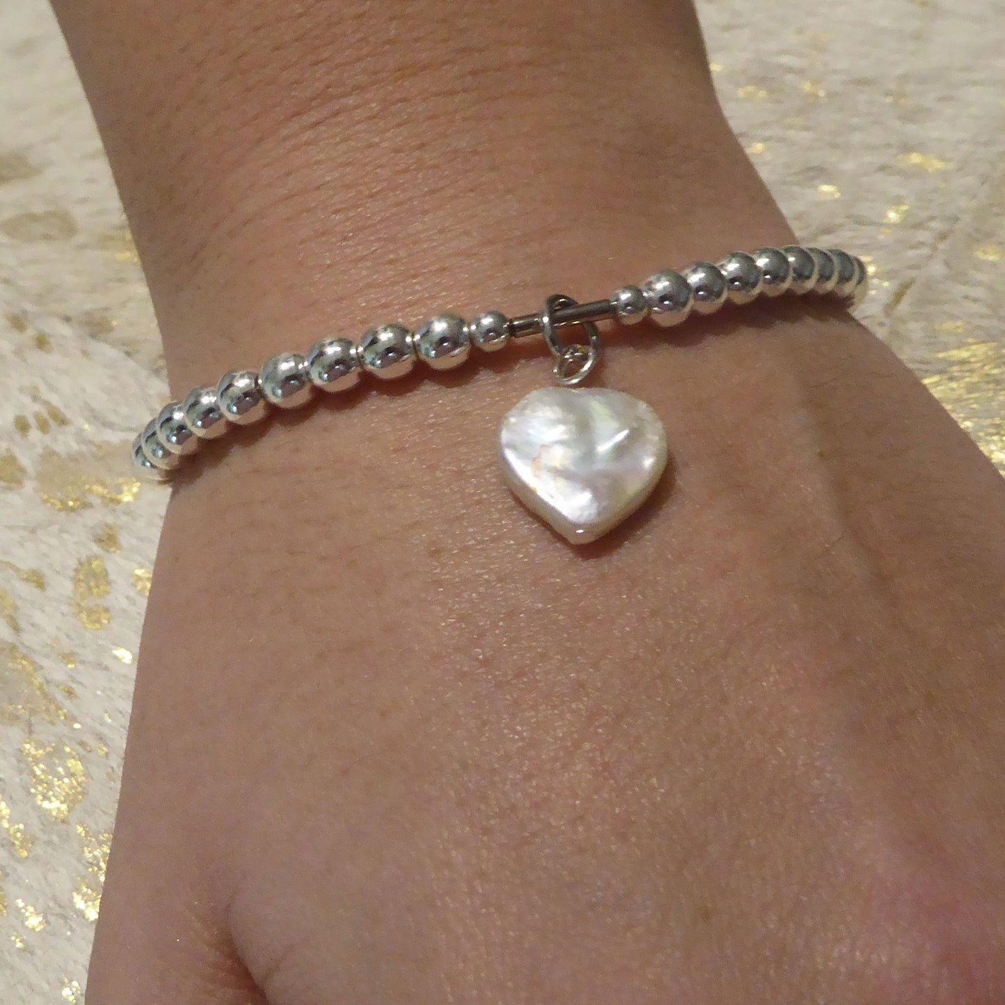 Freshwater pearl heart charm on silver plated hematine