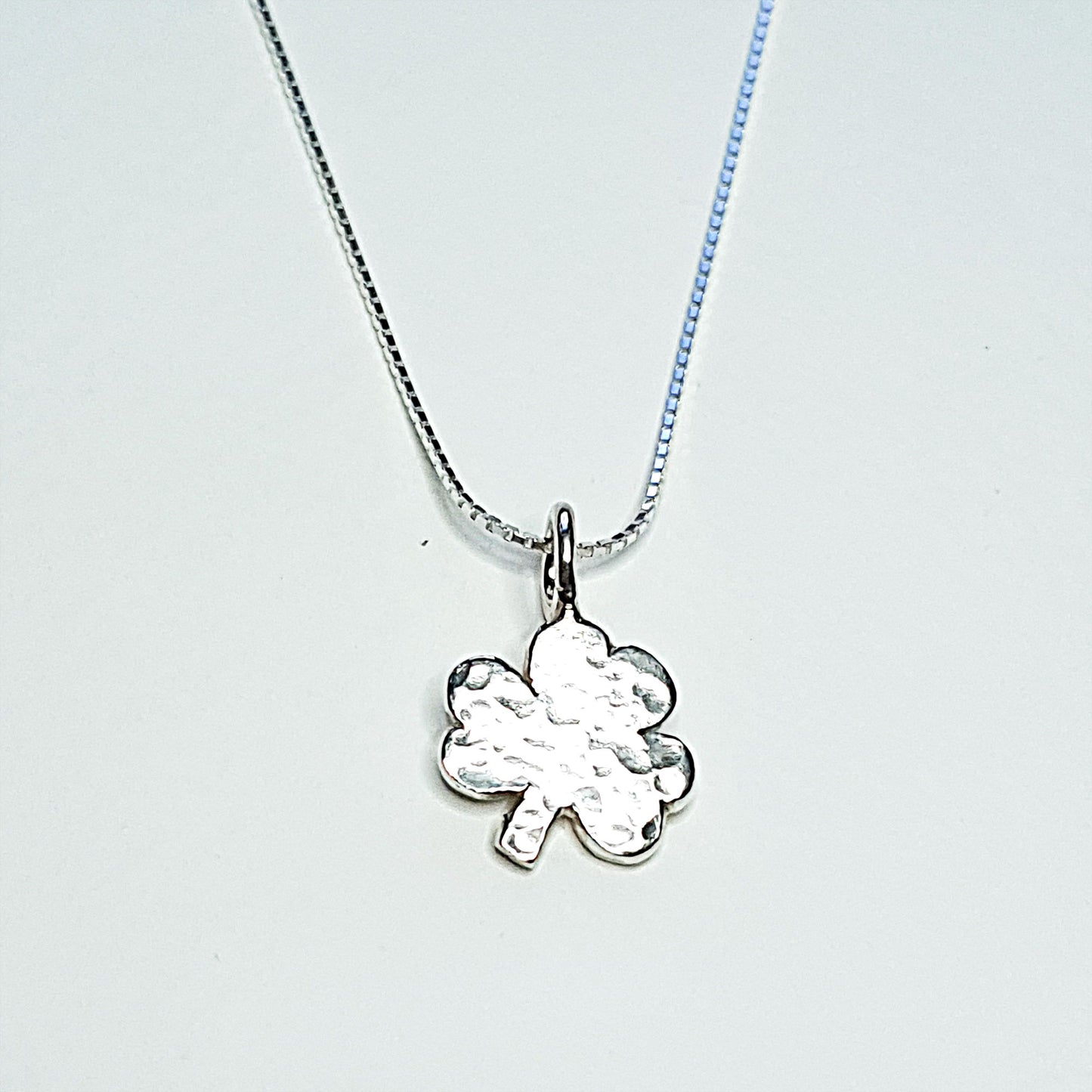 A delicate sterling silver shamrock on a silver chain