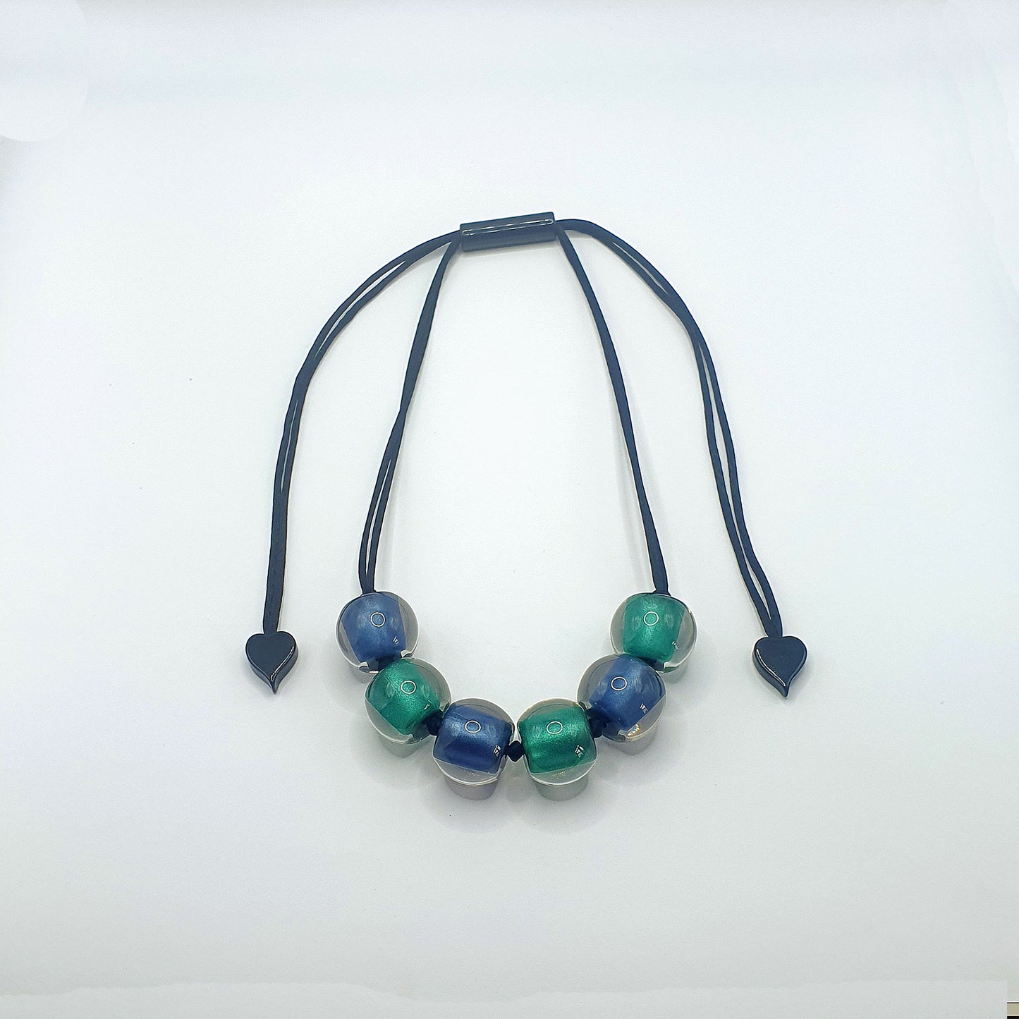 Blue and teal resin beads on an adjustable length cord