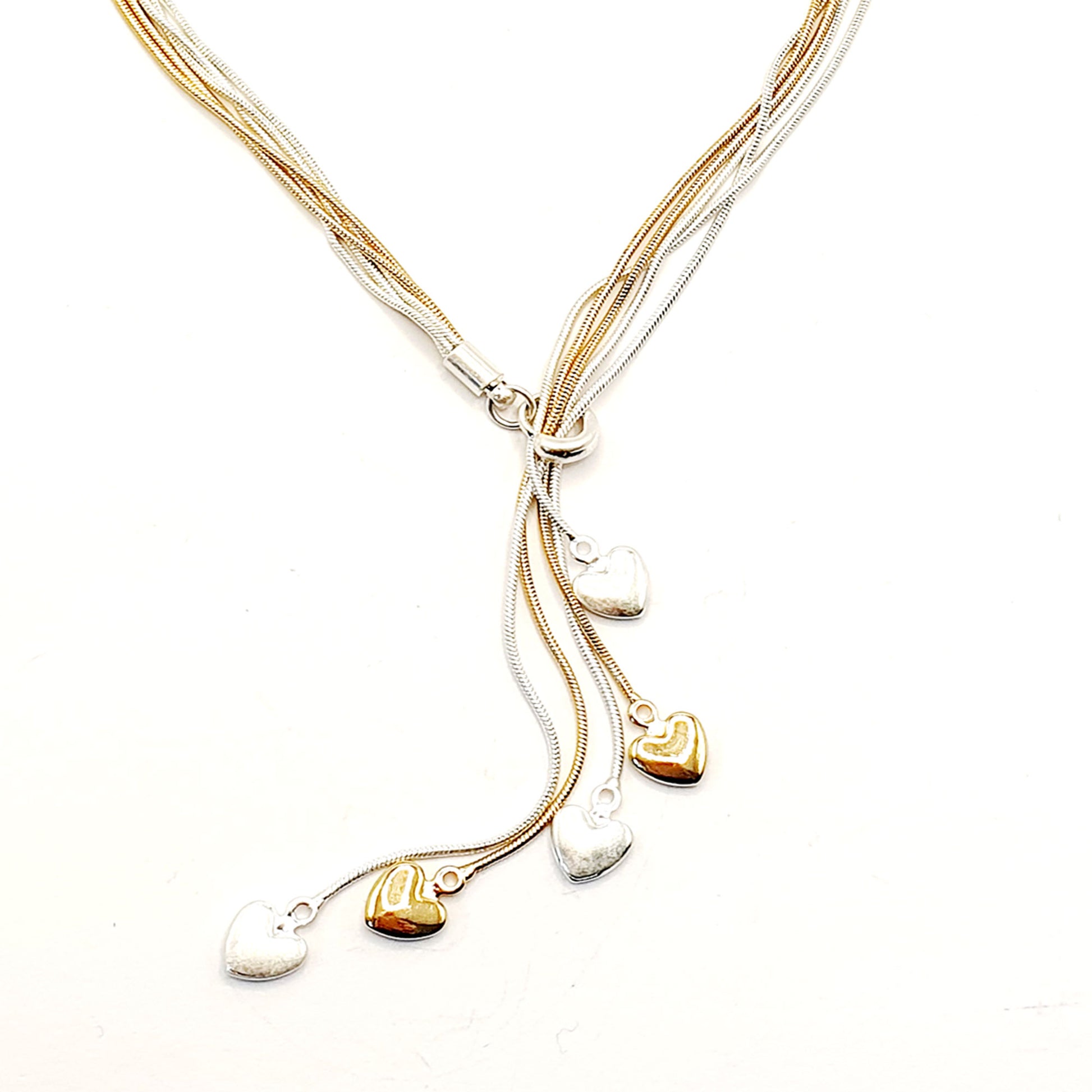 Five strands of silver and gold plated chains with heart charms.