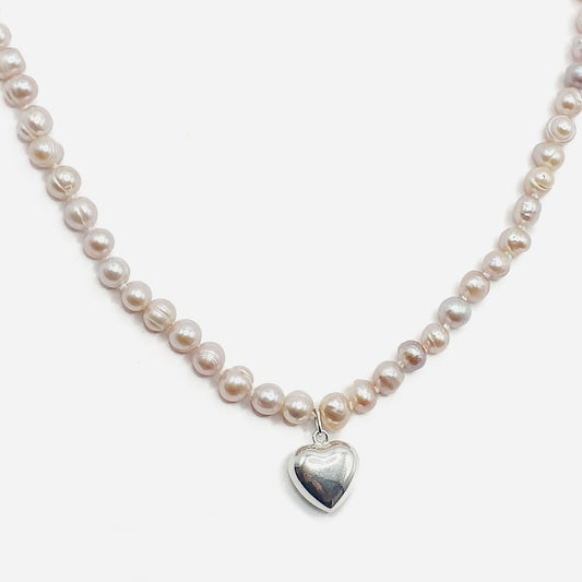 Delicate freshwater pearl necklace in pink with a sterling silver puff heart