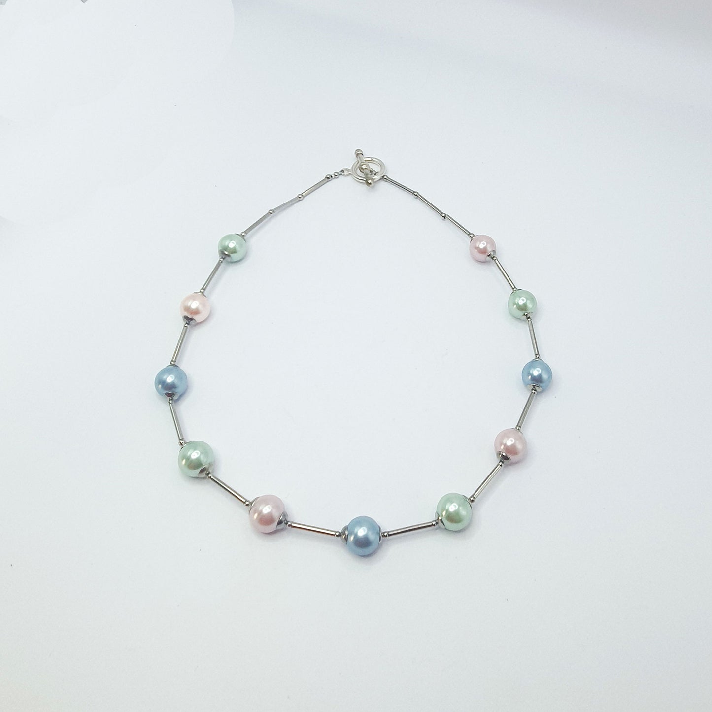 Glass pearl orb-style necklace in pastel shades of blue,  pink and green