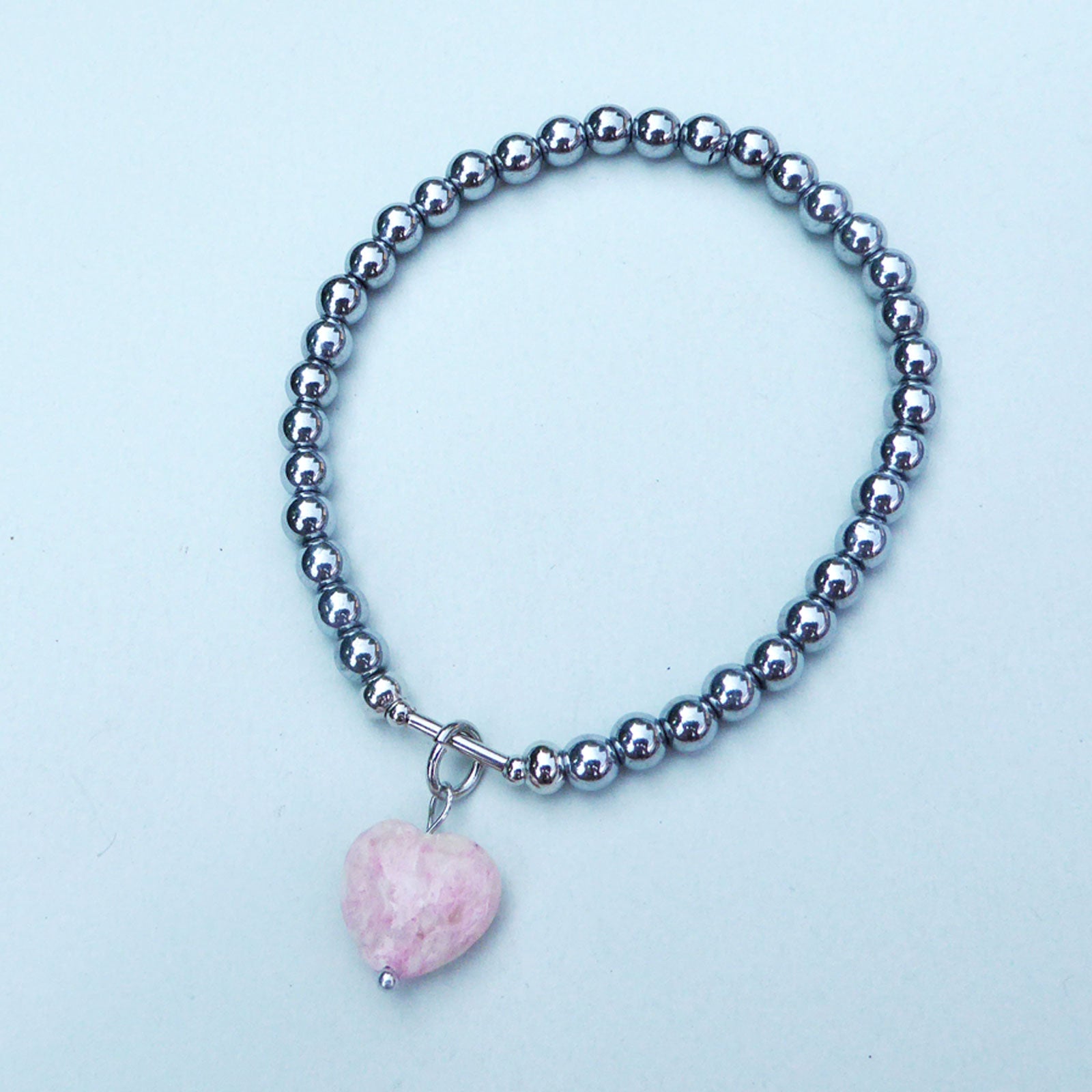 Pale pink fossil heart charm bracelet