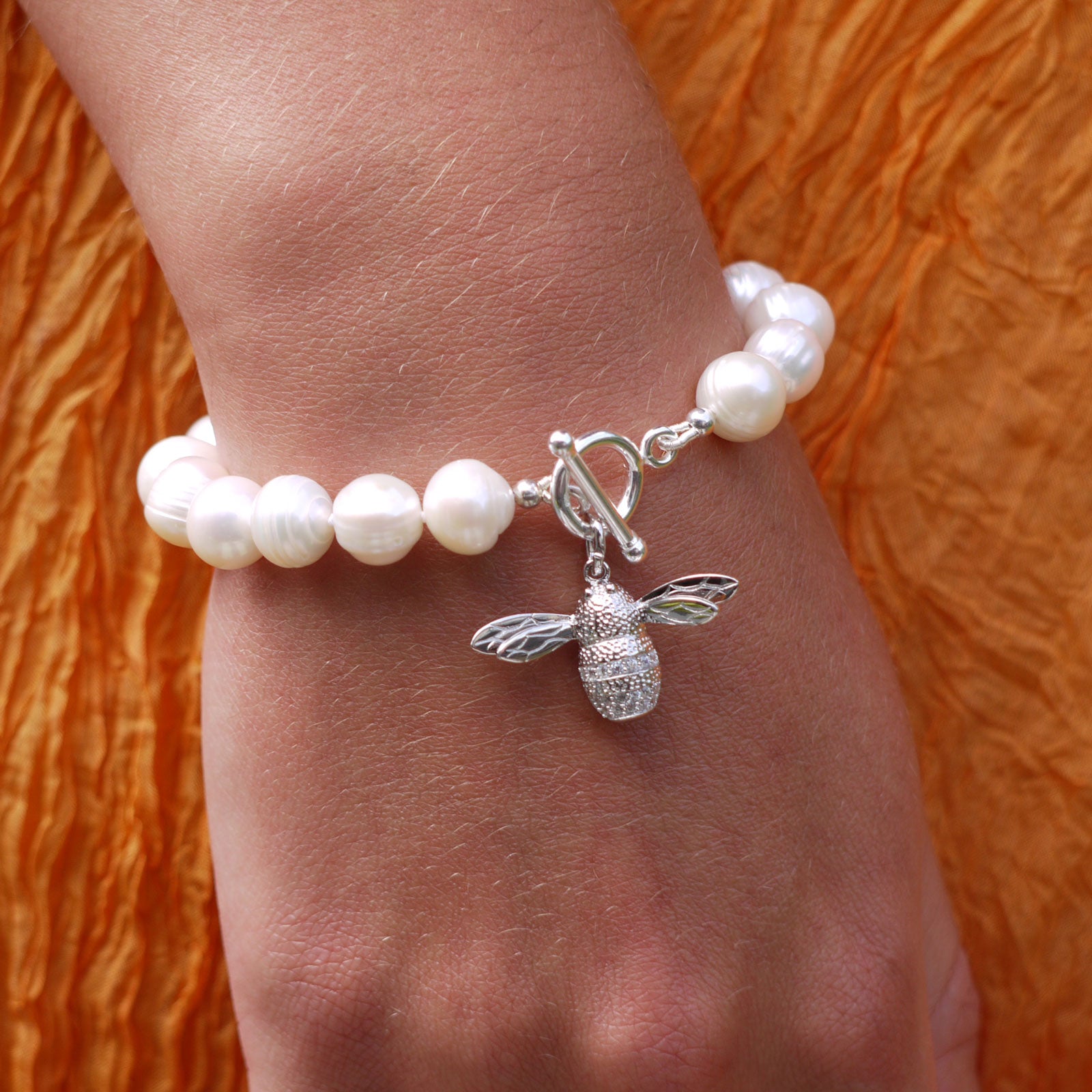 White freshwater pearls and silver bee charm