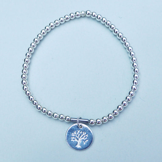 Tree of life disc charm bracelet on a hematine band