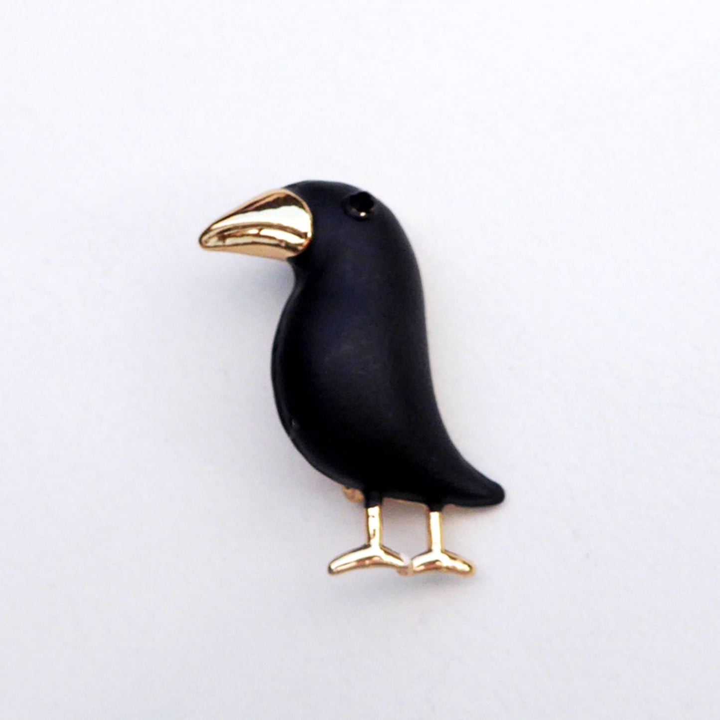 Black metal bird with gold plated feet and beak