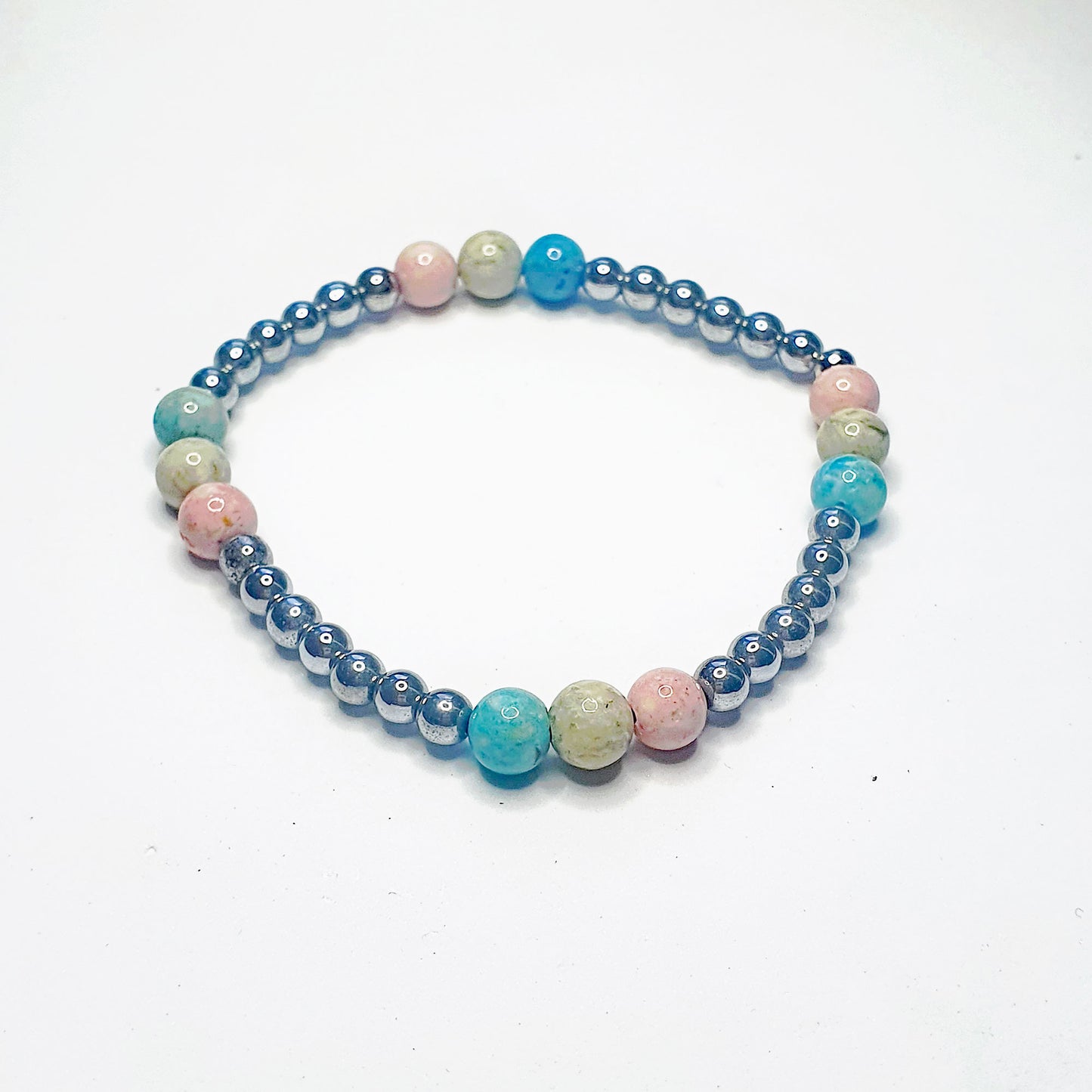 Hematine & fossil ball bracelet in blue green and pink