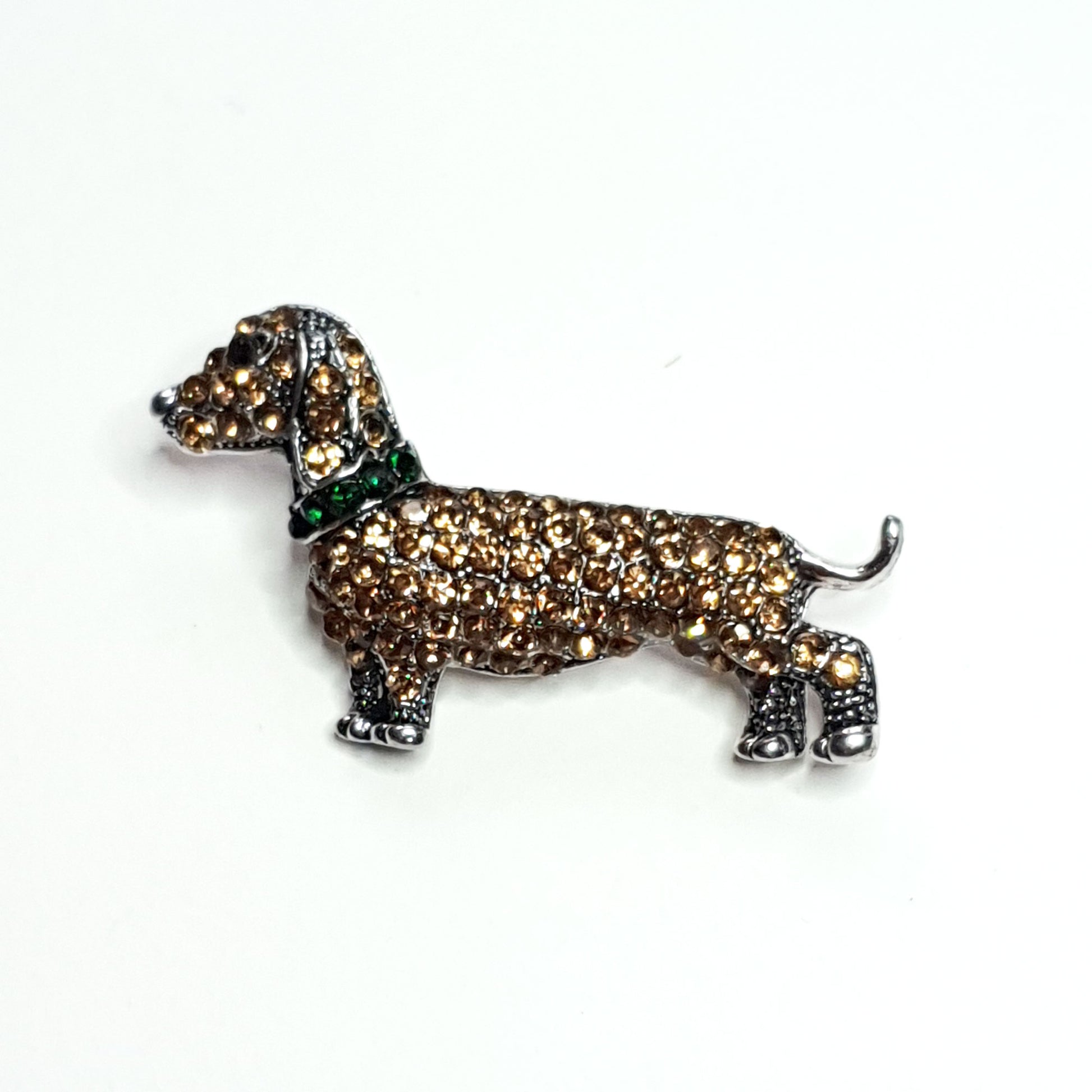 Dachshund brooch of gold diamante stones with a green collar