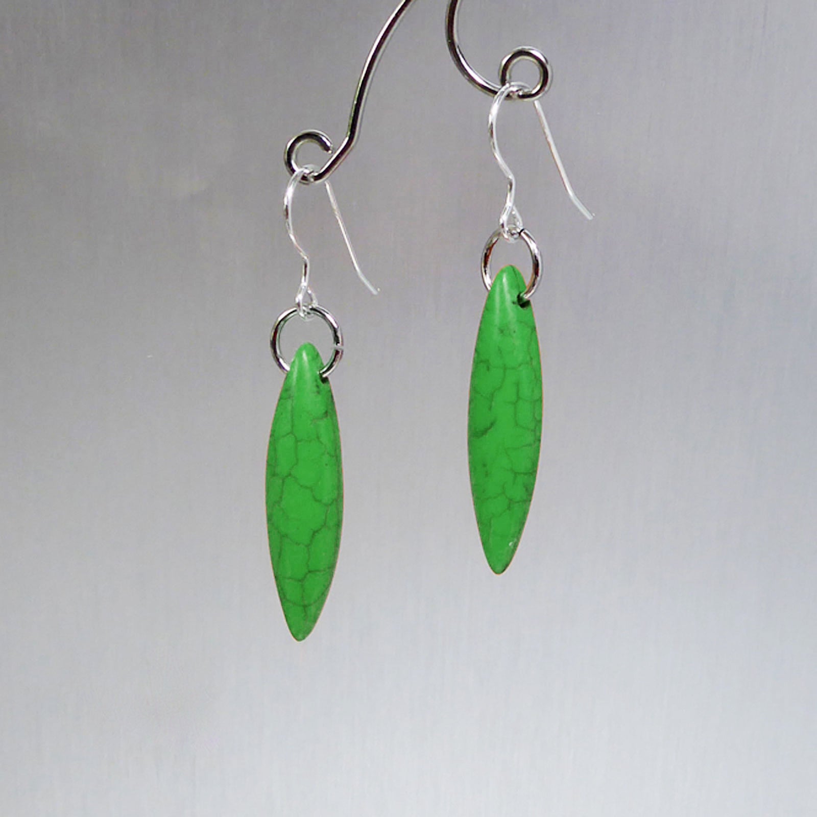 Green elliptical howlite earrings