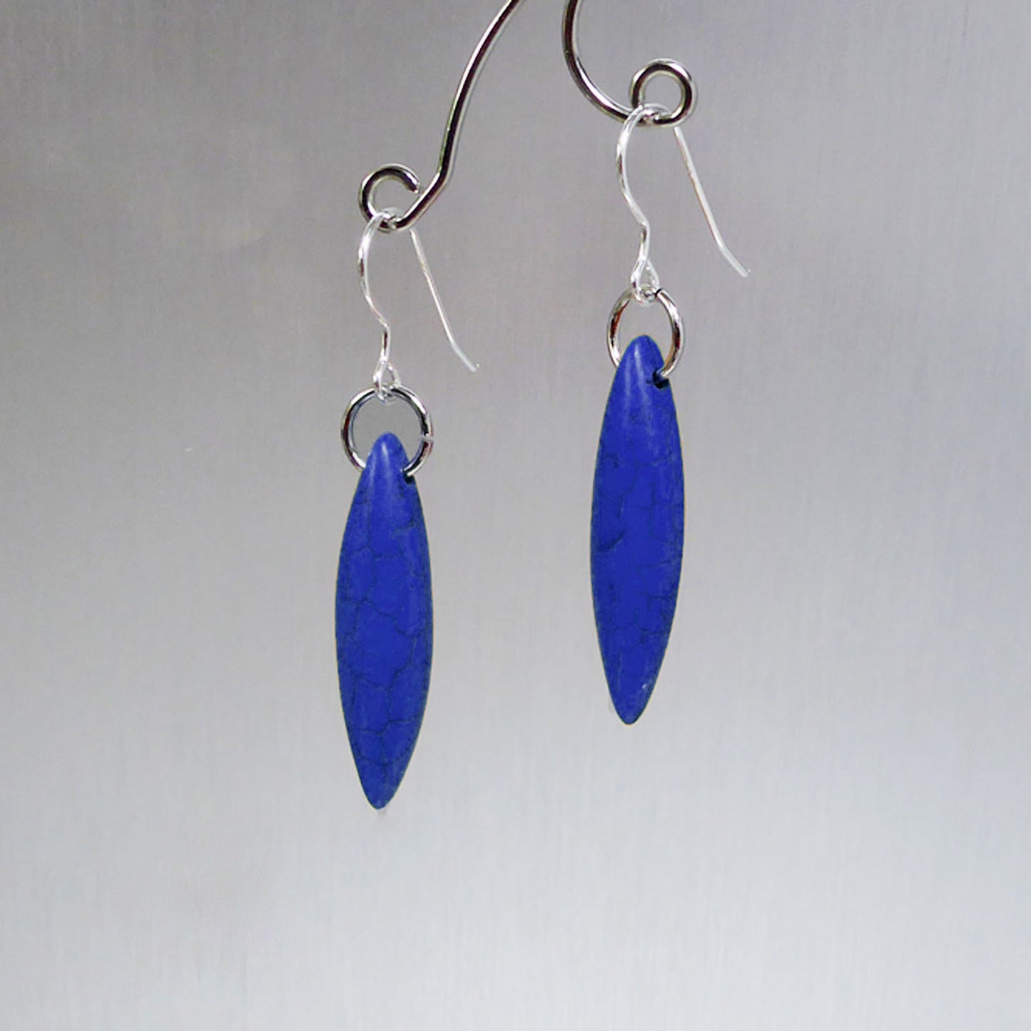 Dark blue elliptical howlite earrings