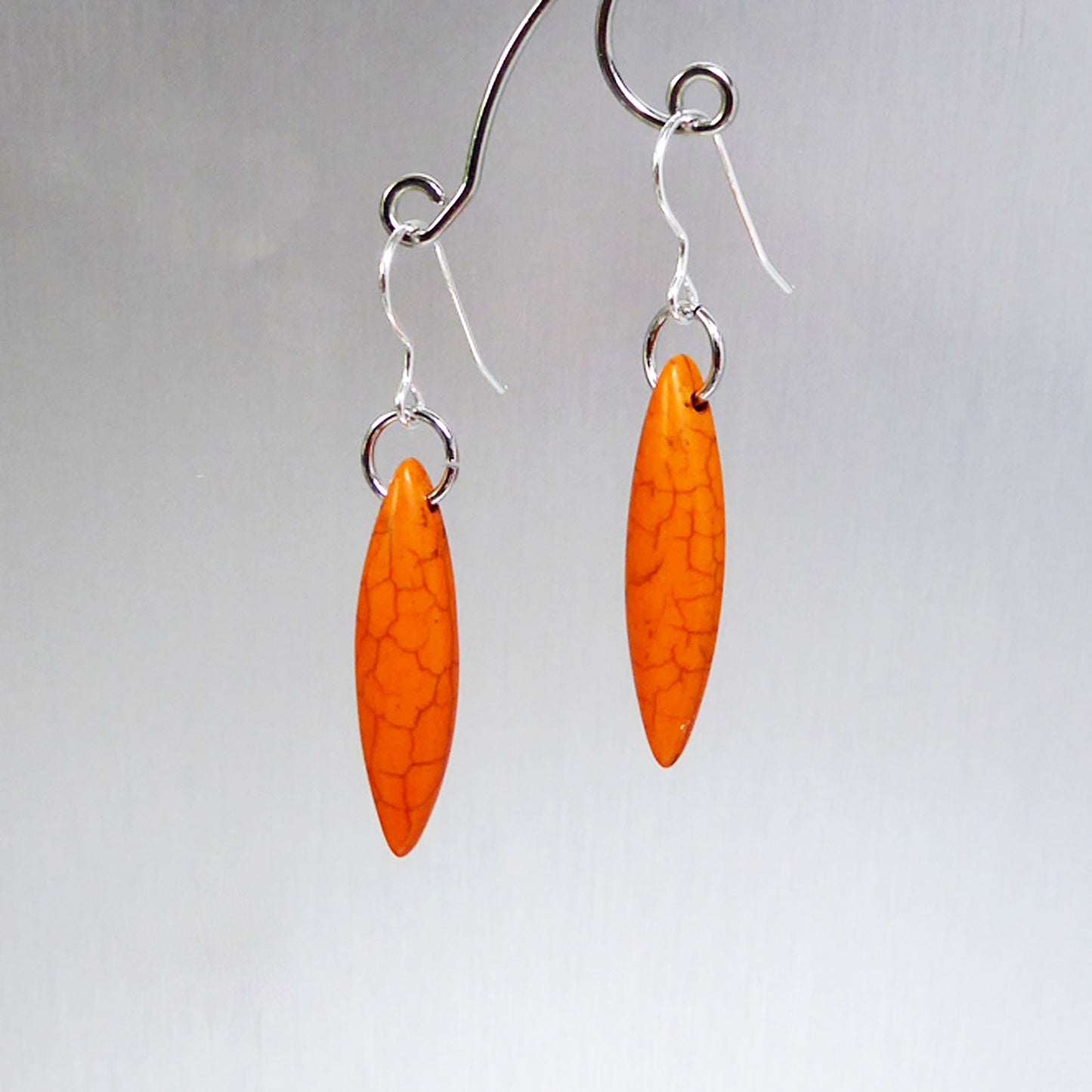 Orange elliptical howlite earrings