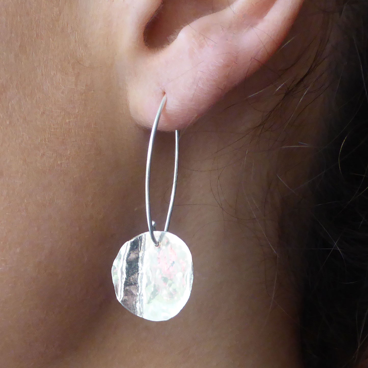 Handmade sterling silver wave disc earrings on oval ear wires