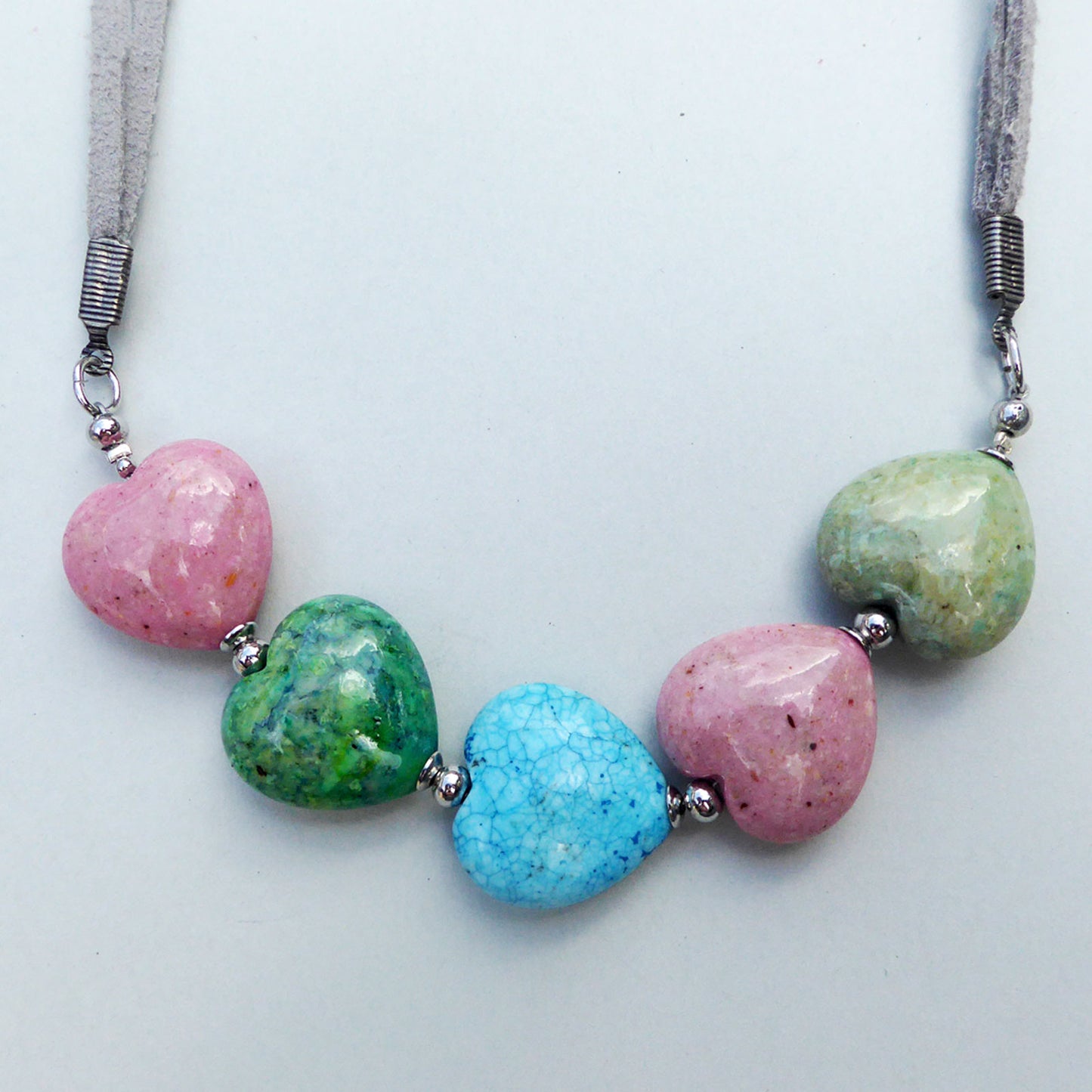 Fossil heart necklace in pink blue and green