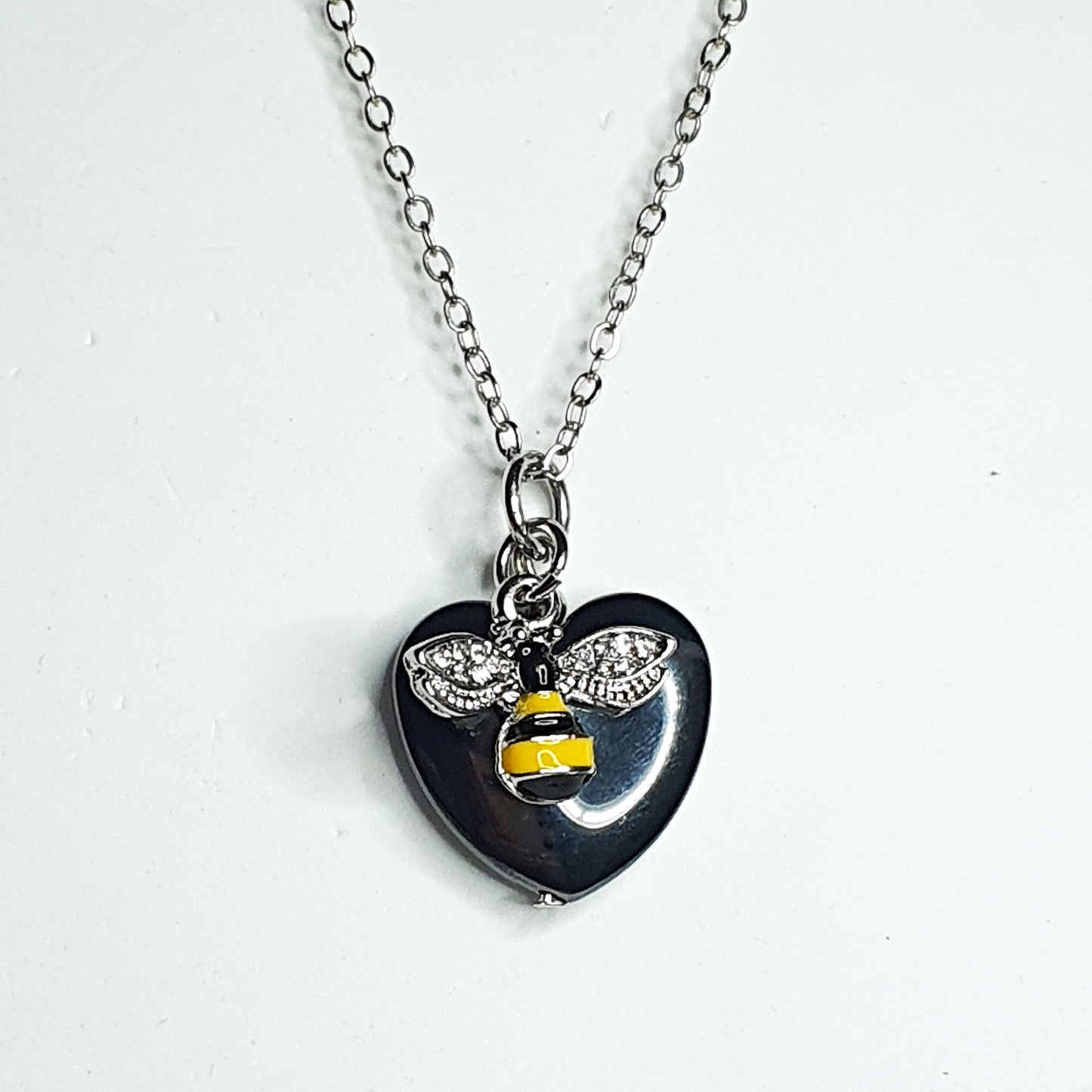 Hematite heart and enamelled black and yellow bee on a silver plated chain