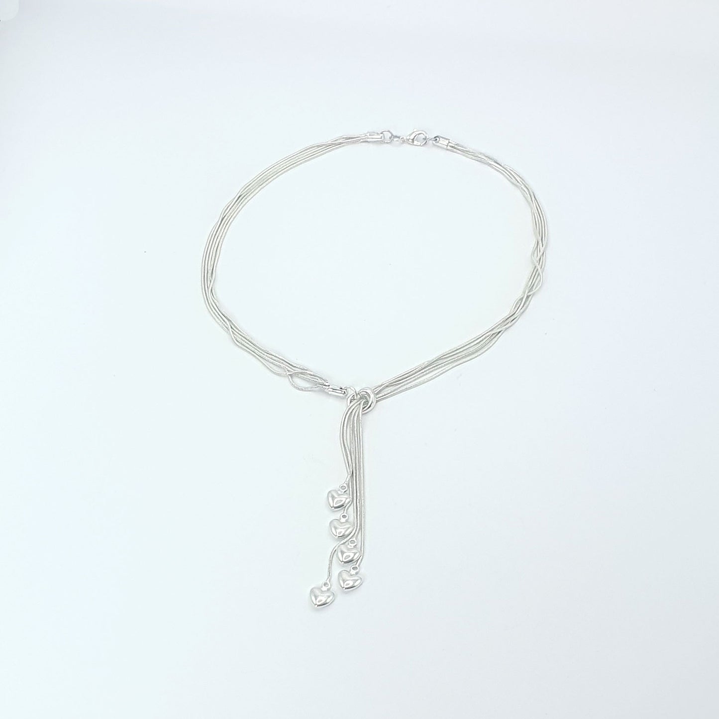 Five strands of silver plated chains with heart charms.
