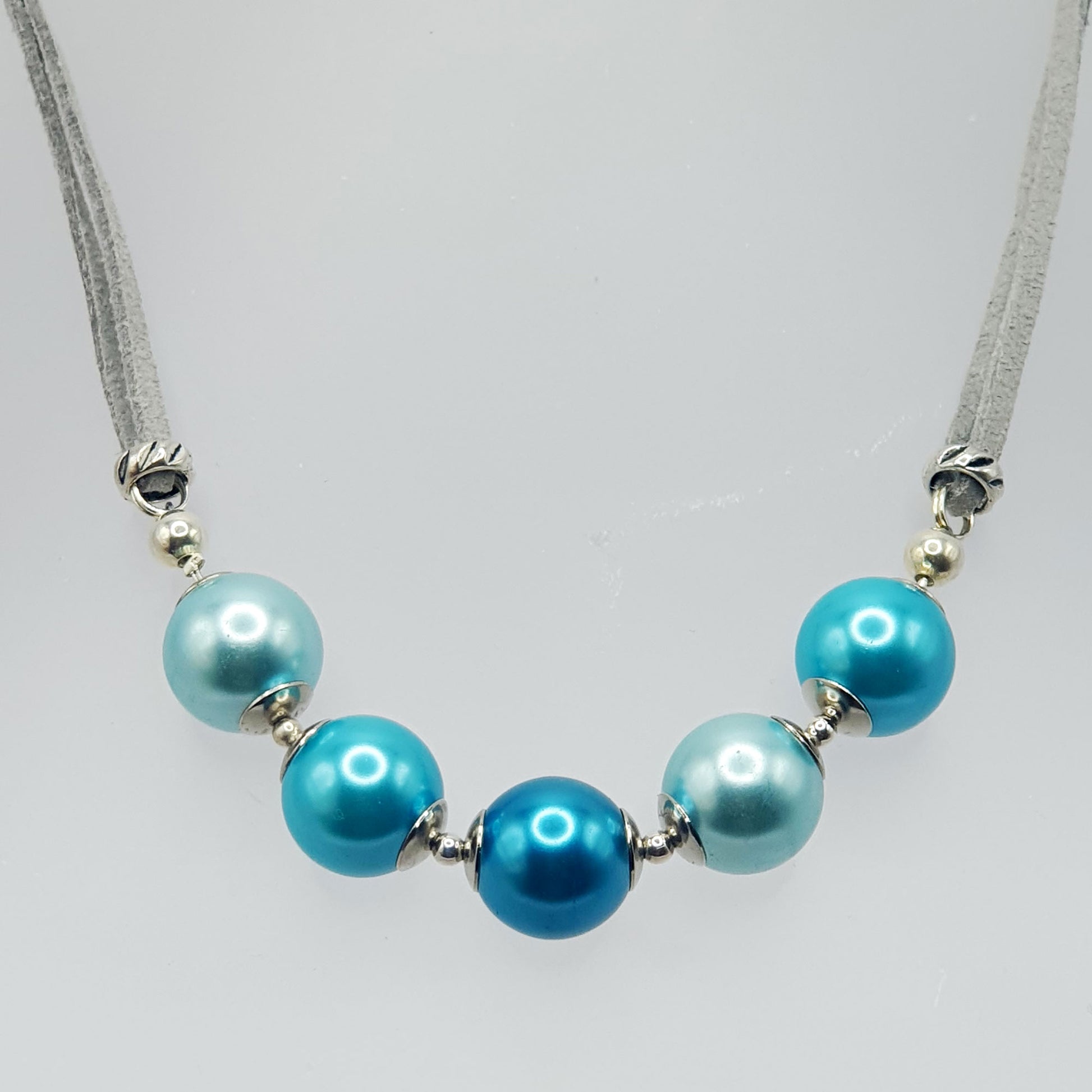 Glass pearl crescent necklace in blue tones