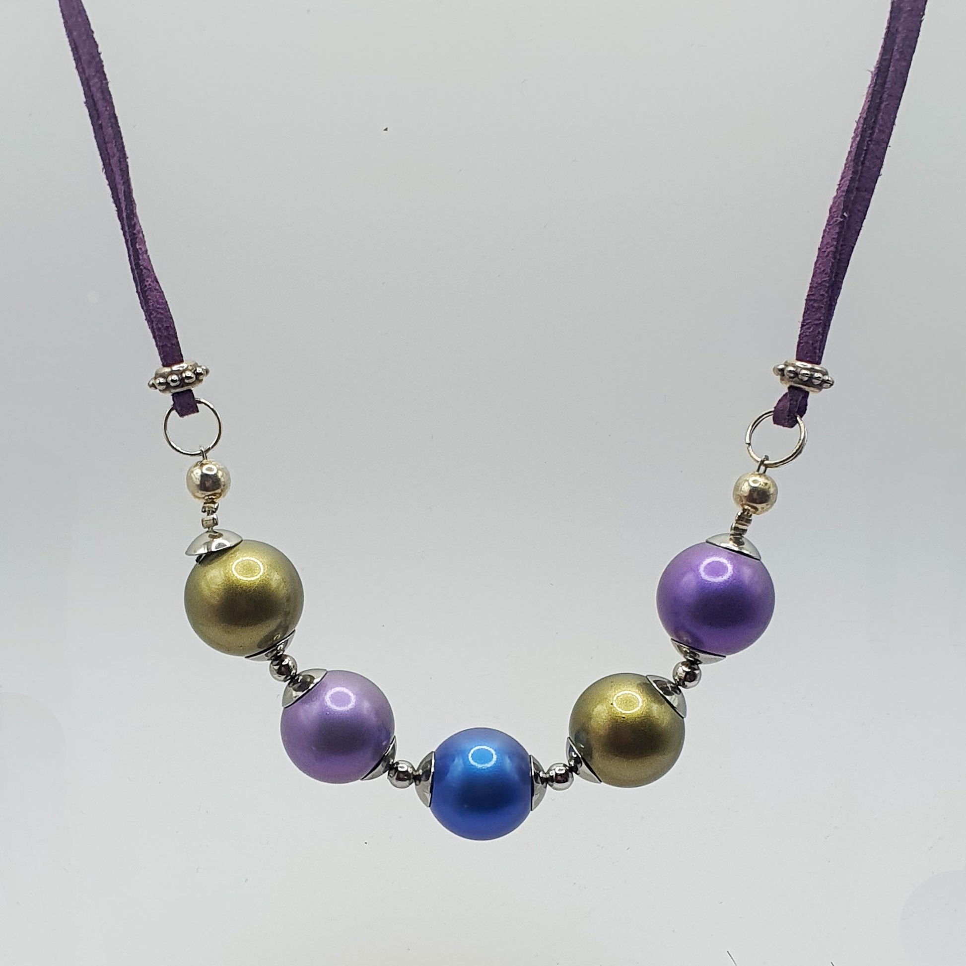 Glass pearl crescent necklace in green, blue and purple tones
