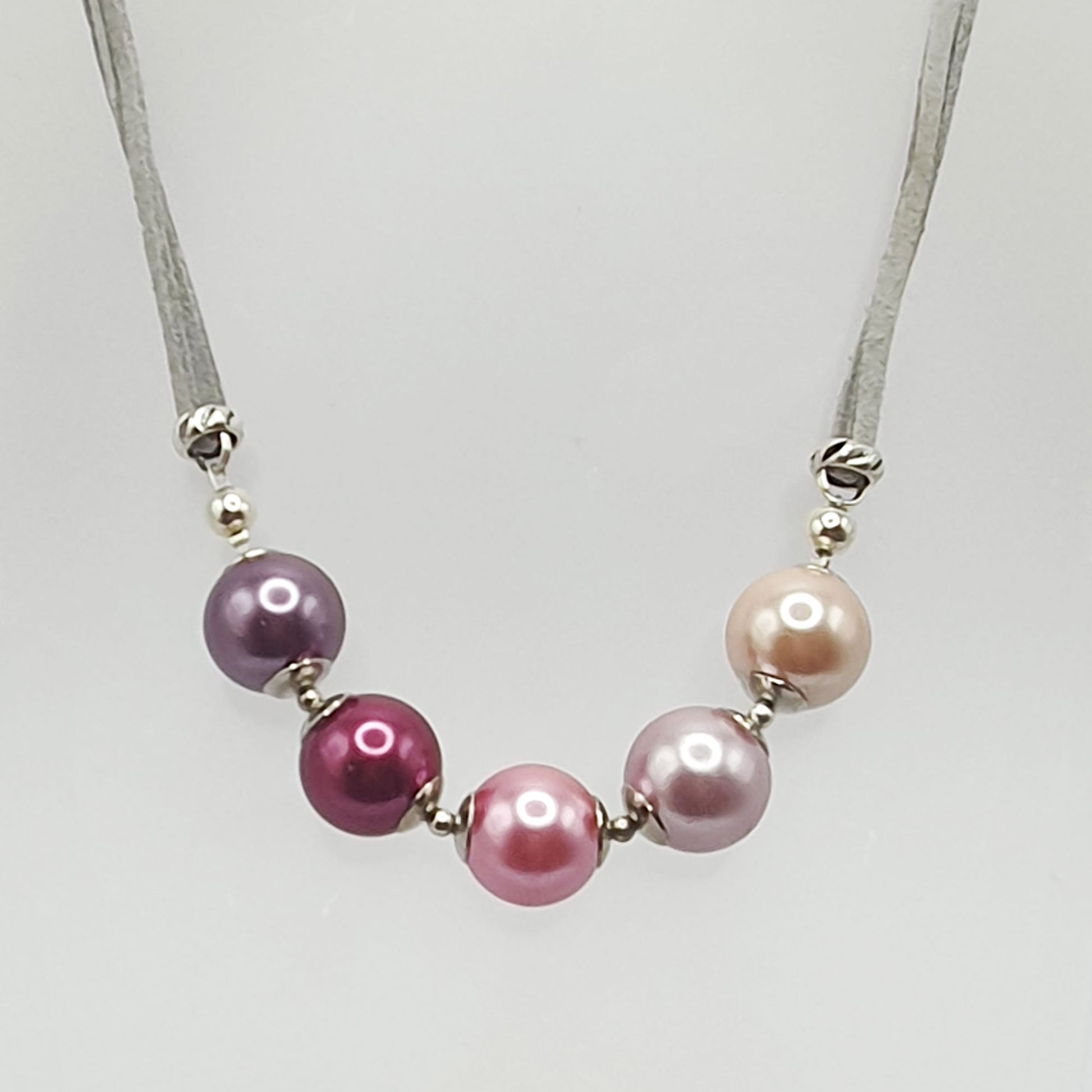 Glass pearl crescent necklace in pink tones